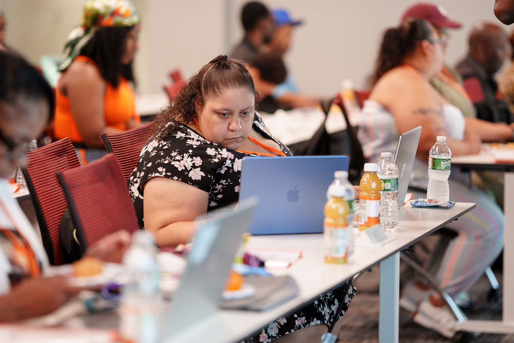 Attendees working together on laptops